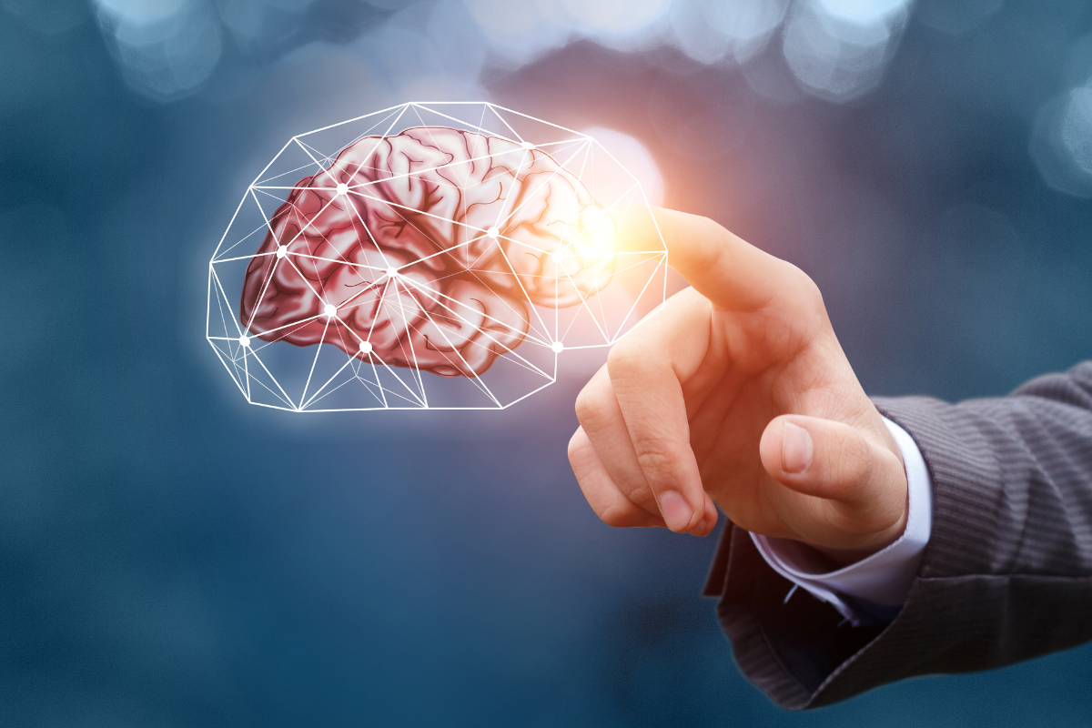 A Finger Pointing At A Brain Showing A Positive Mindset - The Kern Group Ontario Sales Leaders