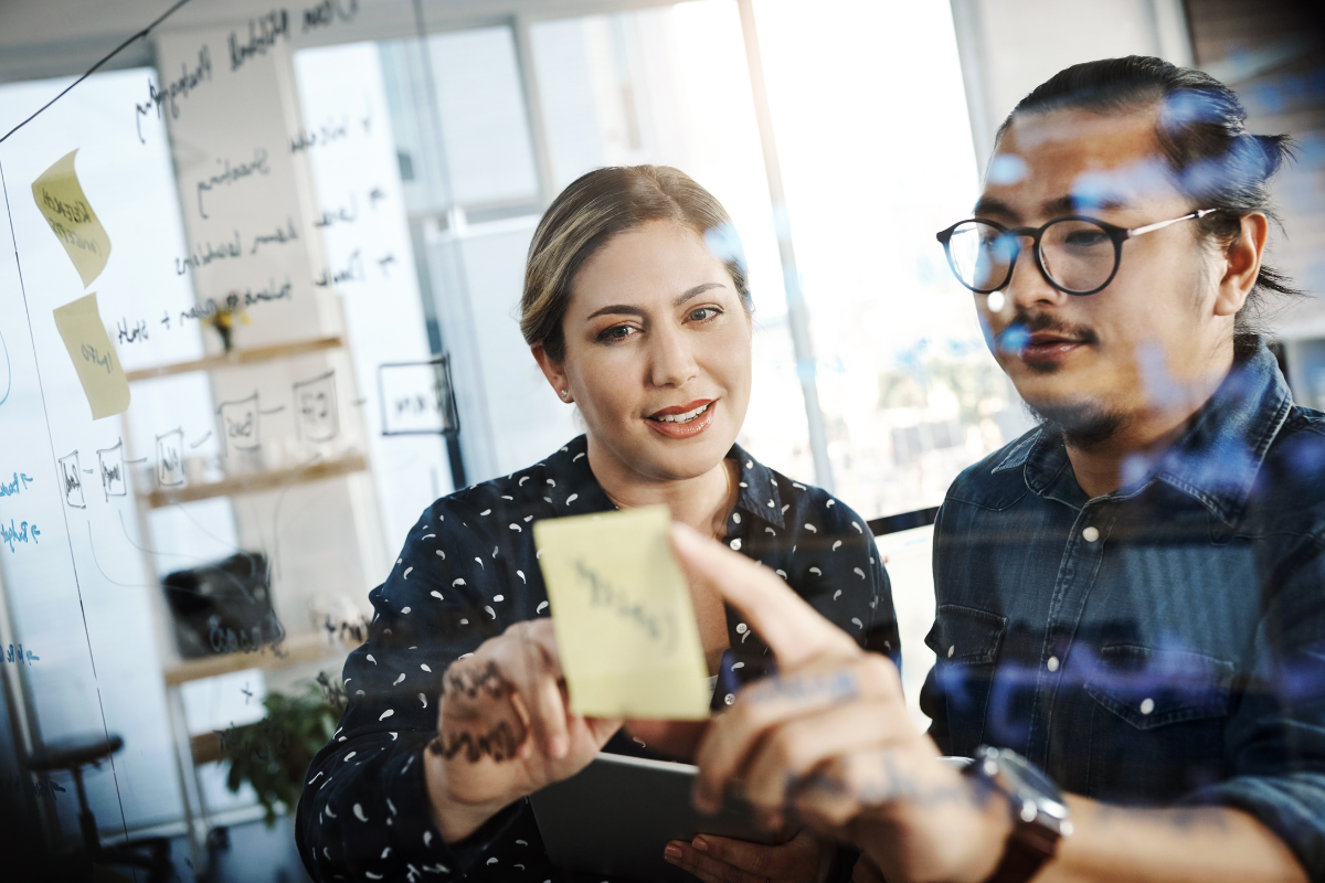 Two SalesPeople Working On A Board - The Kern Group Ontario Sales Leaders